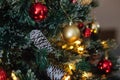 Red and golden balls on a Christmas tree with lights and bokeh Royalty Free Stock Photo