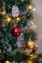 Red and golden balls on a Christmas tree with lights and bokeh Royalty Free Stock Photo