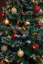 Red and golden balls on a Christmas tree with lights and bokeh Royalty Free Stock Photo