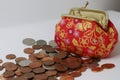 Red and golden fabric purse for small coin, euro cents, penny coins. Chinese/ asian pattern bag. Money saving for future concept. Royalty Free Stock Photo