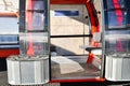 Red gondola ski cable way lift isolated with open door and empty seats in Goderdzi ski resort. Georgia