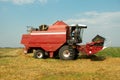 Red grain harvester combine in a field Royalty Free Stock Photo