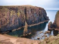 Red granite cliffs and sea stack on Muckle Roe, Shetland, UK - these rocks are of the Muckle Roe Intrusion Royalty Free Stock Photo