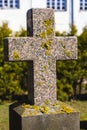 Red granite cross with lichen. Old stone cross in the old cemetery Royalty Free Stock Photo