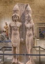 Red granite statues of the King Merenptah and the goddess Mut in the NMEC in Cairo, Egypt.