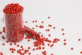 Red granules of polypropylene, polyamide in a measuring beaker and a test tube on a white background. Chemical products. Plastic, Royalty Free Stock Photo