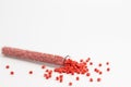 Red granules of polypropylene, polyamide in a measuring beaker and a test tube on a white background. Chemical products. Plastic, Royalty Free Stock Photo