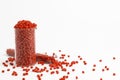 Red granules of polypropylene, polyamide in a measuring beaker and a test tube on a white background. Chemical products. Plastic, Royalty Free Stock Photo