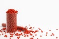 Red granules of polypropylene, polyamide in a measuring beaker and a test tube on a white background. Chemical products. Plastic, Royalty Free Stock Photo