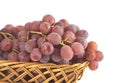 Red grape on branch in straw wicker basket isolate Royalty Free Stock Photo