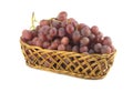 Red grape on branch in straw wicker basket isolate Royalty Free Stock Photo