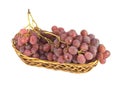 Red grape on branch in straw wicker basket isolated Royalty Free Stock Photo