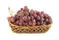 Red grape on branch in straw wicker basket isolated Royalty Free Stock Photo