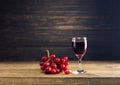 Red grape juice in a glass placed on a wooden table or red wine, a delicious natural healthy juice drink. With a bunch of fresh Royalty Free Stock Photo