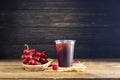 Red grape juice plastic glass With a bunch of grapes, fruit, food, natural sweet taste On a dark black wooden background Royalty Free Stock Photo