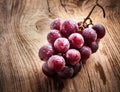 Red grape on wooden table Royalty Free Stock Photo