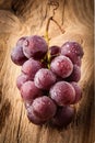 Red grape on wooden table Royalty Free Stock Photo