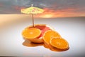 Red Grapefruit and clementines on white with cocktail umbrella Royalty Free Stock Photo