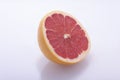 Red grapefruit, cut in half, fresh natural, juicy fruit on a white background Royalty Free Stock Photo