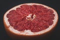 Red grapefruit cut in half, still life, fruit on a black background Royalty Free Stock Photo