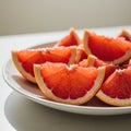 Red Grapefruit Slices on a White Plate Royalty Free Stock Photo