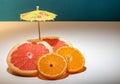 Red Grapefruit on white with cocktail umbrella Royalty Free Stock Photo