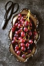 Red grapes in cupronickel platter on a gray background. Royalty Free Stock Photo