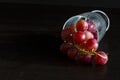 Red grapes, large bunch of fruits, fresh and tasty simple food on a dark background in a fancy minimal composition