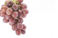 Red grapes placed on a white background Royalty Free Stock Photo