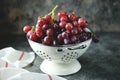 Red grapes in a white colander on a gray background. Royalty Free Stock Photo