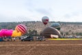 Red - gray hot air balloon flies up from the ground at the hot air balloon festival