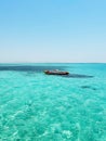 Red and gray inflatable boat on clear turquoise water Royalty Free Stock Photo