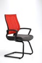 Red and gray office chair with plastic arms and iron legs Royalty Free Stock Photo