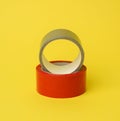 Red and gray scotch tape isolated on a yellow background Royalty Free Stock Photo