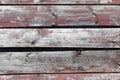 Red-gray wooden background. horizontal boards. old paint peels off. old boards. Red gray wood texture of a worn painted board. Red Royalty Free Stock Photo