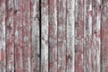 Red-gray wooden background. vertical boards. old paint peels off. old boards. Red gray wood texture of a worn painted board. Red Royalty Free Stock Photo