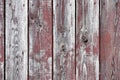 Red-gray wooden background. vertical boards. old paint peels off. old boards. Red gray wood texture of a worn painted board. Red Royalty Free Stock Photo