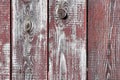 Red-gray wooden background. vertical boards. old paint peels off. old boards. Red gray wood texture of a worn painted board. Red Royalty Free Stock Photo