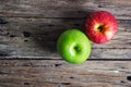 Red and green apple on old wooden table Royalty Free Stock Photo
