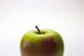 A red and green apple with water drops isolated on a white background. Royalty Free Stock Photo