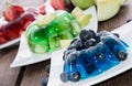 Red, green and blue Jello with fruits
