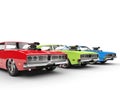 Red, green and blue muscle cars in a row