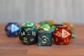 Red, green and blue w6 and w20 role playing dice on table with other dice in blurry background Royalty Free Stock Photo