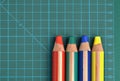 RGBY red, green, blue and yellow colored pencils on a cutting mat Royalty Free Stock Photo