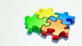 Red, green, blue and yellow jigsaw puzzle pieces on white background with copy space. Teamwork or team building, riddle, solution Royalty Free Stock Photo