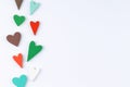 Red, green, brown and blue hearts on a white background. Royalty Free Stock Photo