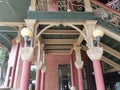 Red and green building with columns and stairs