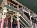 Red and green building with columns and stairs