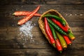 Red and green chili pepper on plate on wooden background Royalty Free Stock Photo