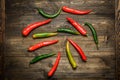 Red and green chili pepper on plate on wooden background Royalty Free Stock Photo